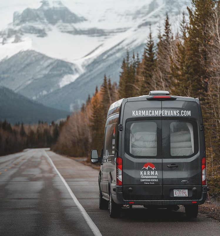 The back of a Karma Campervan driving through the Rocky Mountains.
