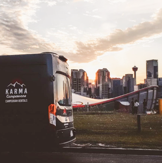 A Karma campervan with the Calgary skyline in the distance.