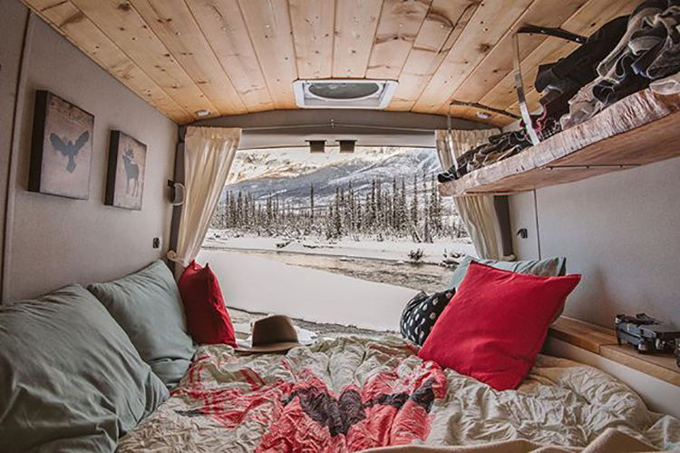 The view of snowcovered mountains from a Karma campervan.