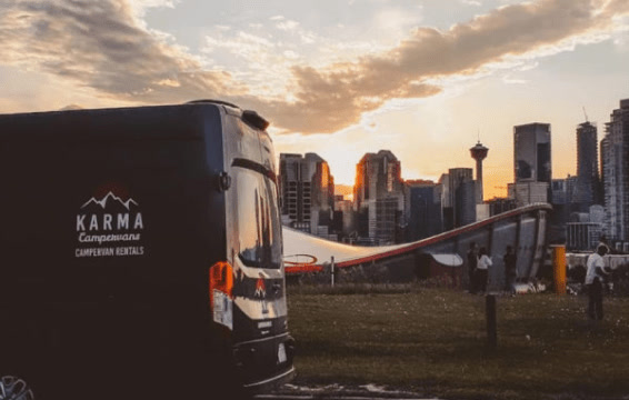 A Karma campervan with the Calgary skyline in the background.