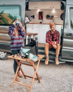 two people outside their karm camper van