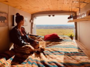 Inside Karma Campervan overlooking bed and beautiful view 