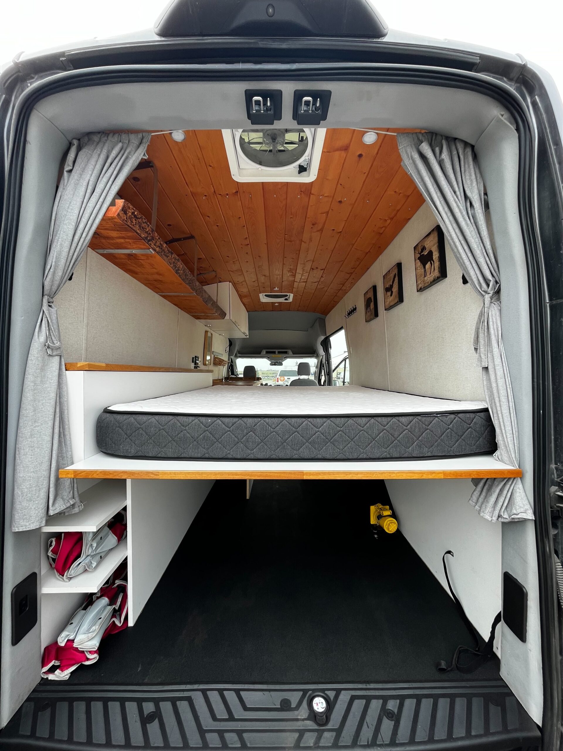 back of a camper van with a mattress