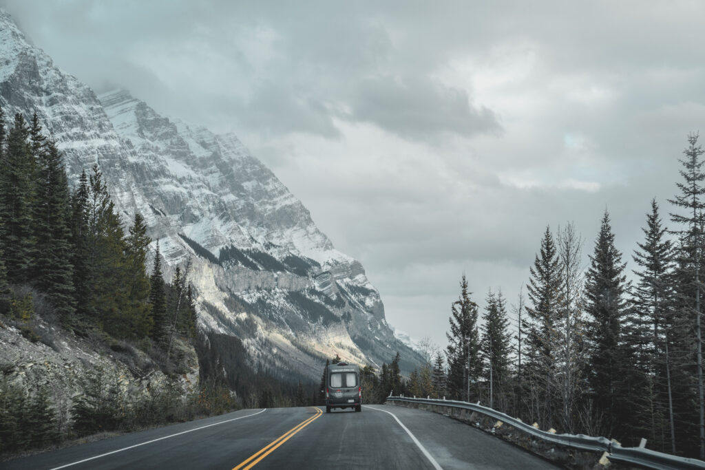 a highway with a mountain range with a karma camper van