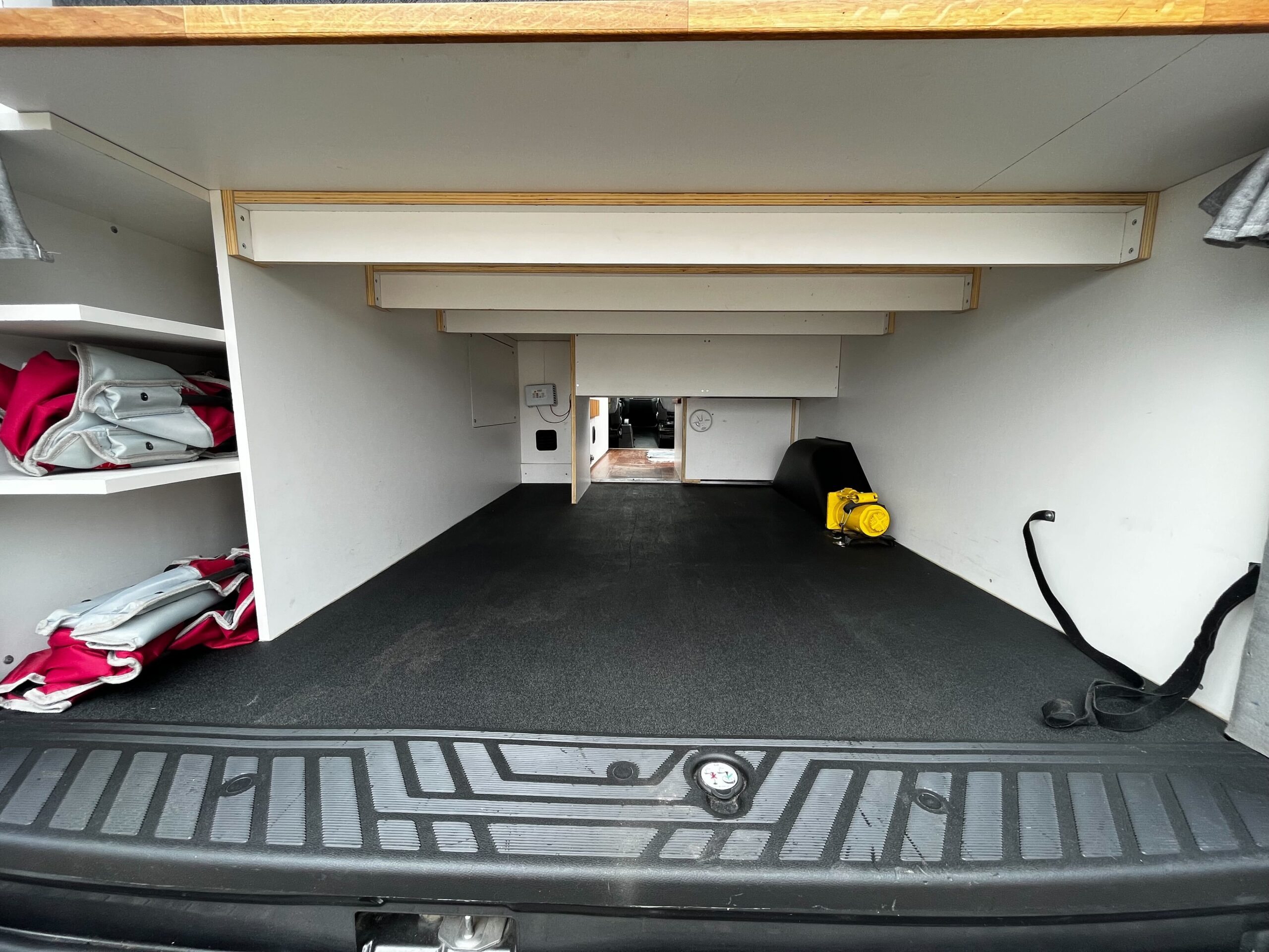 camper van interior with white shelving