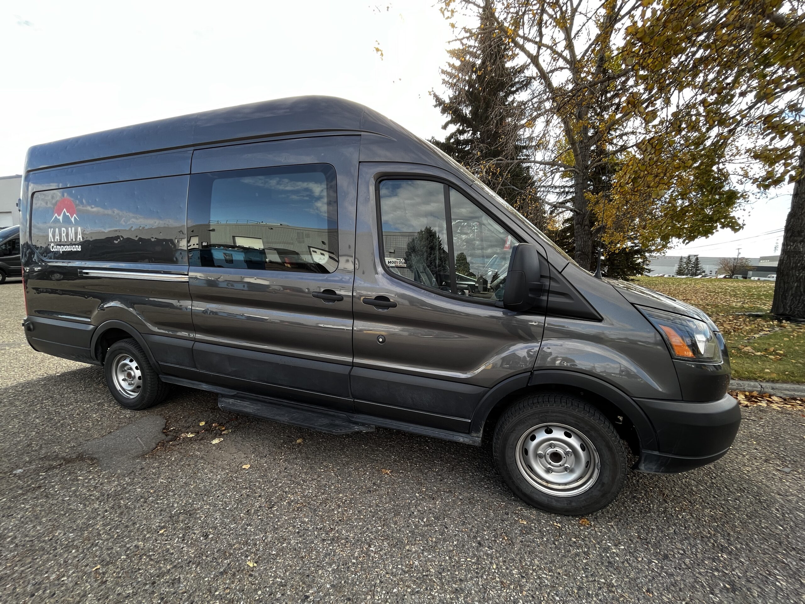 passenger side view of a grey camper van